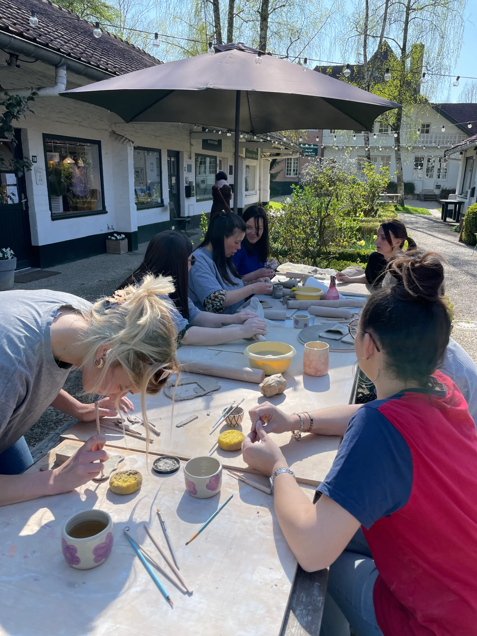 Participants réunis autour de la terre dans l’atelier My Pot’Art